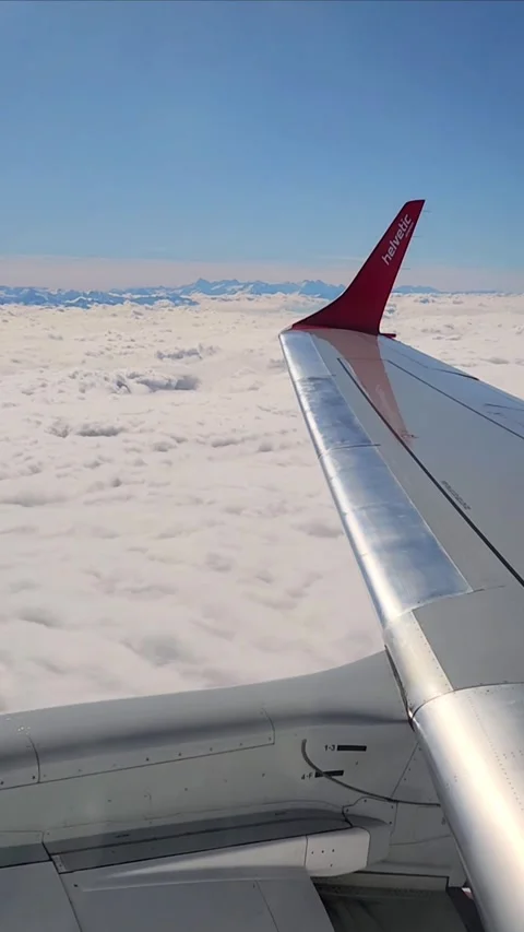 Swiss Airline Flight over the clouds  Editorial Use Only Stock-Footage 317319182