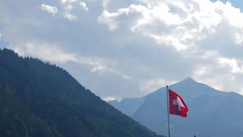 Swiss Flag and Mountain Range in a Sunny Summer Day Video stock 265486168