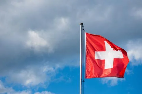 Swiss Flag in Cloudy Sky Close Up Stock-Fotos