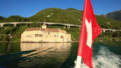 Swiss flag in foreground on lake Geneva Stock Footage