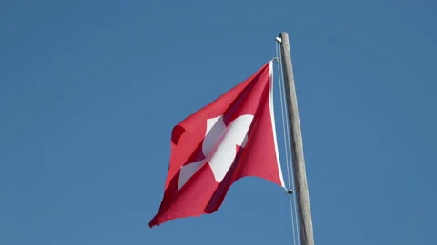 Swiss flag slow motion daylight Switzerland mountains outdoor handheld Stock Footage 204089411