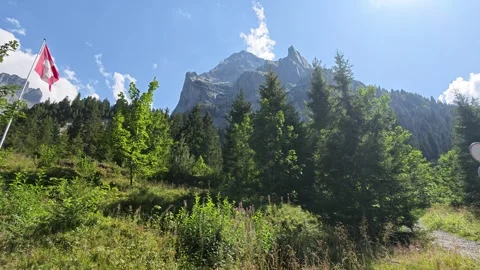 Swiss Flag Surrounded By Giant Towering Mountain Peaks In Schwarzwaldalp Stock Footage 346606509