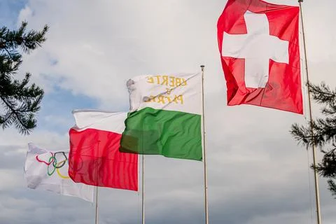 Swiss flags waving under cloudy sky in Lausanne Switzerland Stock Photos