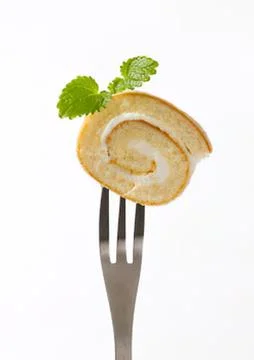 Swiss roll with cilantro on a fork Stock Photos