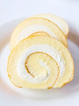 Swiss roll on white background. Stock Photos