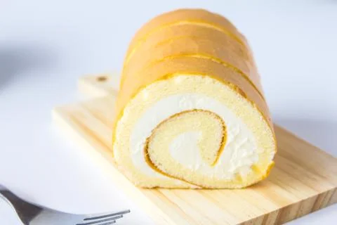 Swiss roll on white background. Stock Photos
