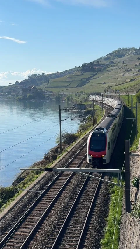 Swiss SBB train approaching Lavaux Lake Geneva railway Switzerland Stockbeeldmateriaal 332998525