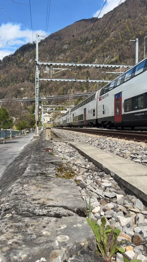 Swiss SBB train passing by Lake Geneva with mountain backdrop Stock-Footage 331984067