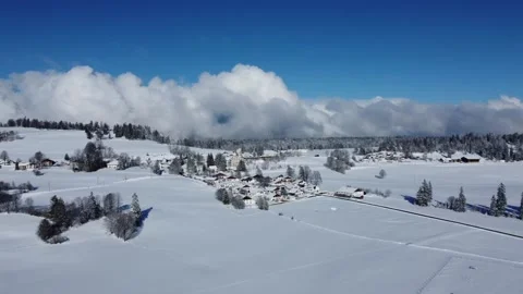 Swiss village Le Bémont drone footage with clouds in the back Stock Footage
