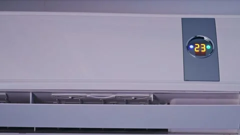 Switch on air conditioning to blow cool air changing the room temperature Stock Footage 265247155