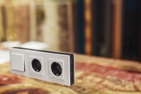 Switch and socket mounted in a mirrored wall Stock Photos