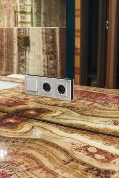 Switch and socket mounted in a mirrored wall Stock Photos