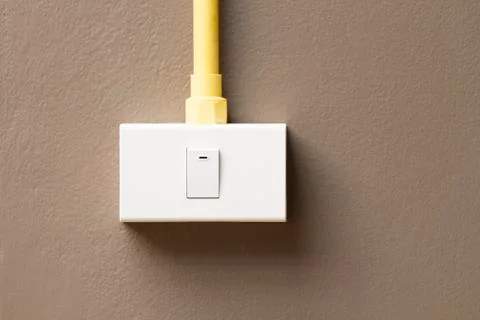 Switch and sockets on dark brown wall Stock Photos