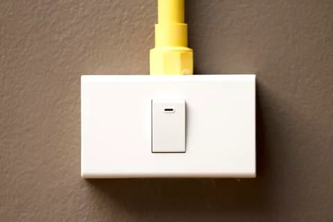 Switch and sockets on dark brown wall Stock Photos