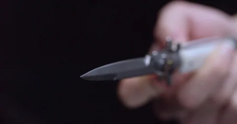 A switch blade flips open right at camera, medium focus / ALPHA MATTE Stock Footage 71782991