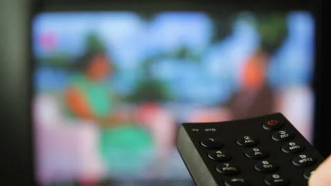 Switch channels on the TV with remote control Stock Footage 96423705