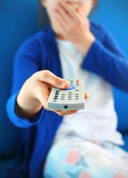 Switch off. Child with tv remote control Stock Photos