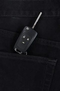 Switch key is lying in side pocket of black pants. Stock Photos