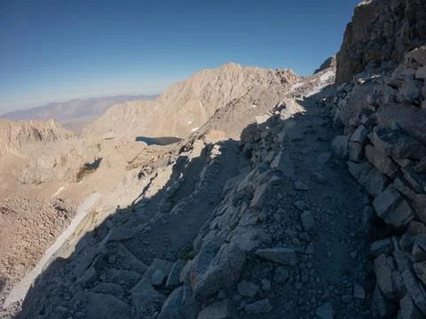 Switchbacks leading from top of Mount Whitney with snow remnants in high el.. Stock Photos