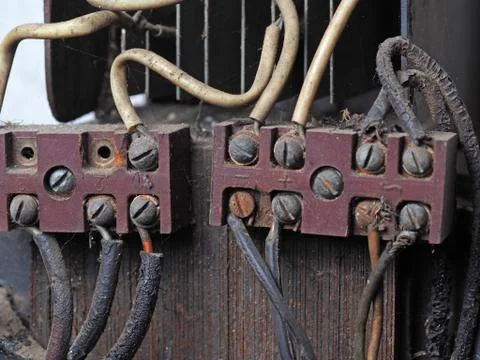 Switchboard old close-up, with connected wires. Side view Stock Photos
