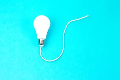 A :Switched on light bulb on a light blue background - a symbol of a new idea Stock Photos