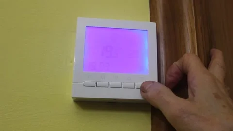 Switching on a heating thermostat Stock Footage 322026882