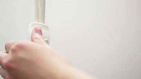 Switching light on a white switch. Home interior. Button against the wall Видео 155880855