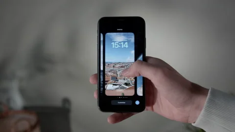 Switching Lock screen on a iPhone with IOS 16, POV Stock Footage 217767657