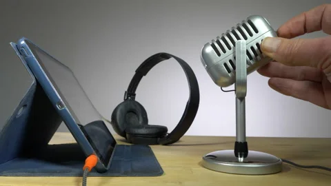 Switching on microphone next to tablet and headphones. Video stock 143839043