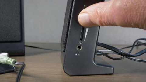 Switching on a pair of small speakers connected to a phone. Video stock 141263649
