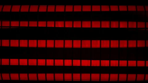 Switching on quartz heater, red-hot elements under metal grid, close-up view. Video stock 306574170