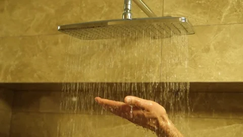 Switching on the shower head in the bathroom, the flow of water and falling Stock Footage 262685315