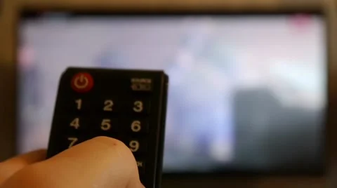 Switching TV channels with the remote 4 Stock Footage 47326157