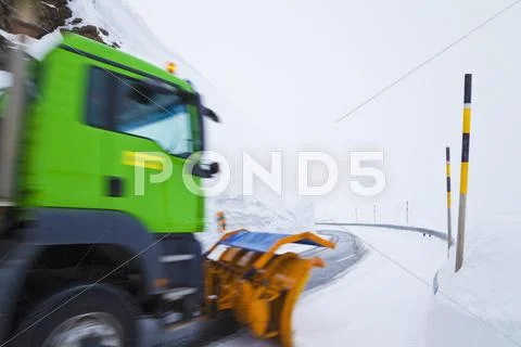 Switzerland, Blurred Truck Clearing Snow On Road