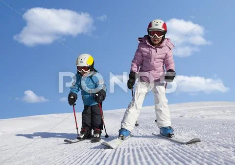 Switzerland, Boy and girl skiing in snow Stock-Fotos