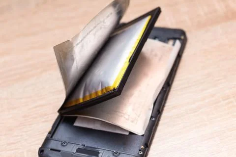 Swollen ready to catch fire or explode a broken battery on the phone Stock Photos