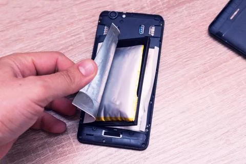 Swollen ready to catch fire or explode a broken battery on the phone Stock Photos