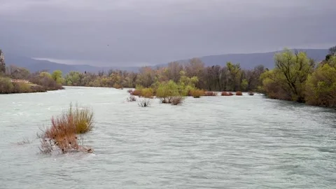 A swollen river. Floods in the spring. A lot of water flows in the river. Stock Footage 305397770
