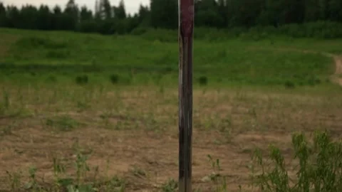 A sword stuck into the ground in the middle of a field Stock Footage 250002575