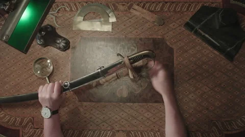Sword on the Table while pricing Antiques Video stock 259610735