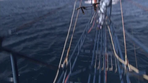 Swordfish hunter at the end of the catwalk prepares the harpoon to hit the fish Stock Footage 79754222