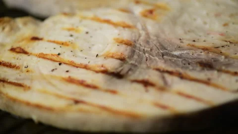 Swordfish Xiphais gladius steak portion cooking on a grill pan Video stock 153312786