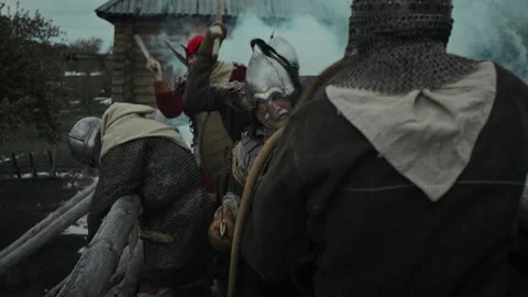 Swordsman in Chainmail Fighting Enemies, Fallen Comrade Slouching over Rail Stock Footage 279466095