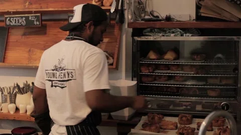 Sydney Cafe Worker Arranging Fresh Pastries in Display Case at Counter Stock Footage 345691358