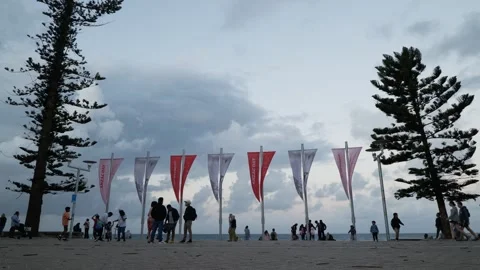 Sydney crowds next to flags at Manly Promenade 6K Stock Footage 307462865