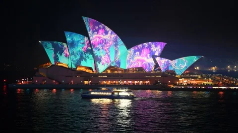 Sydney Ferry moving across the foreground in front of Sydney Opera House at C Stock Footage 128402391