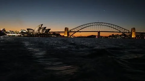 Sydney Harbour Bridge and Opera House at Dusk with Reflections on Water Stock Footage 345719476