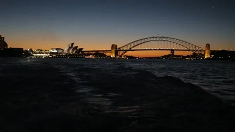 Sydney Harbour Bridge and Opera House at Dusk with Reflections on Water Stock Footage 345719574