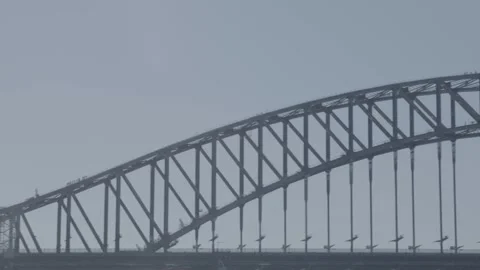Sydney Harbour Bridge Arch and Pylon with Flags and People in Daylight Stock Footage 345717558