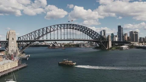 Sydney Harbour Bridge tracking, ferry boats underneath in daytime - Drone Aerial Stock Footage 234587134